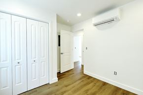 Providence apartment for rent - A white room with a wood floor and a wall-mounted air conditioner.