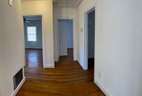Fuquay-Varina house for rent - A room with wooden floors and white walls.