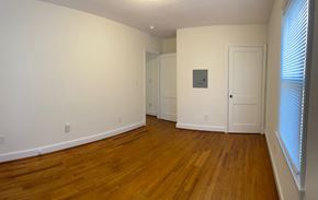 Fuquay-Varina house for rent - A room with wooden floors and white walls.