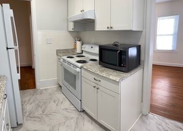 Fuquay-Varina house for rent - A kitchen with a white oven and microwave.