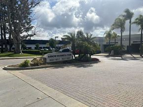 Rancho Cucamonga apartment for rent - The image shows a business parking lot with a sign that reads "Arrow Business Park" and two phone numbers.