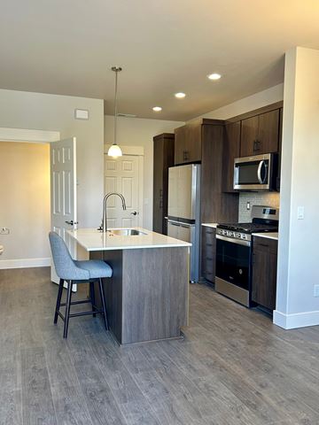 Bend apartment for rent - A kitchen with a bar stool and a counter.