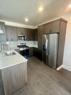 Bend apartment for rent - A kitchen with a refrigerator, sink, and microwave.