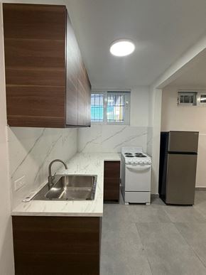 San Juan apartment for rent - A kitchen with a sink, a stove, and a refrigerator.