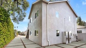Van Nuys apartment for rent - A house with a concrete exterior and a grey roof.