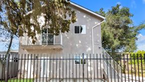 Van Nuys apartment for rent - A white house with a black fence in front.