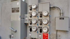 Van Nuys apartment for rent - A series of meters and switches are attached to a grey wall.