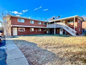 Lakewood apartment for rent - A red brick building with a white balcony and a white door.