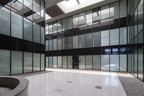 Houston apartment for rent - A modern atrium with glass walls and a white floor.