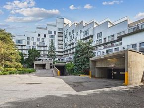 Verdun apartment for rent - A parking lot in front of a white apartment building.