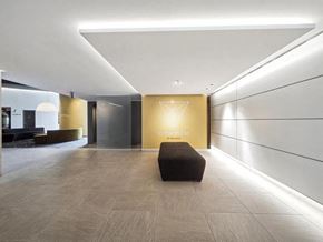 Verdun apartment for rent - A hallway with a bench and a wall with a logo on it.