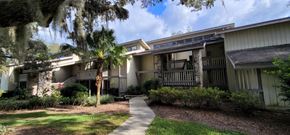 Haines City apartment for rent - A building with a balcony and a tree in front of it.