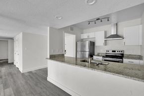 Haines City apartment for rent - A kitchen with a refrigerator, stove, and oven.