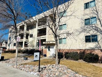 Littleton apartment for rent - A building with a sign in front of it.