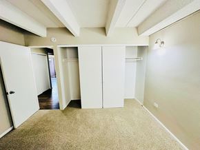 Englewood apartment for rent - A pool surrounded by trees and umbrellas.