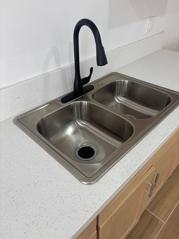 Los Angeles apartment for rent - A double sink kitchen counter with a black faucet.