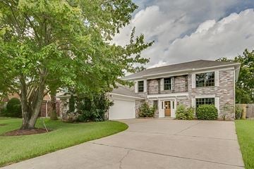 Houston house for rent - A house with a tree in front of it.