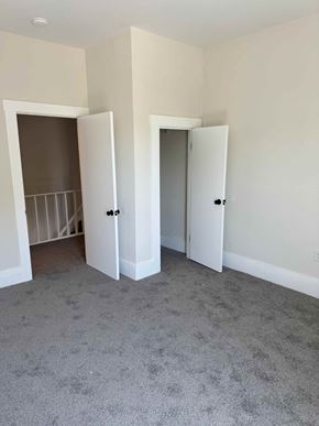 Cridersville apartment for rent - A room with two white doors and a grey carpet.