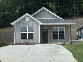 Little Rock house for rent - A small house with a grey exterior and a black door.
