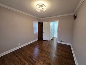 Gary house for rent - A room with wooden floors and a ceiling light.