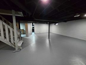 Gary house for rent - A spacious, empty room with a staircase on the left side.