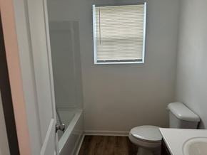 Villa Rica house for rent - A bathroom with a toilet, sink, and shower.