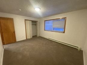 Anchorage apartment for rent - A room with a brown door and a window.