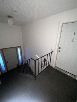 Anchorage apartment for rent - A room with a black railing and a white door.