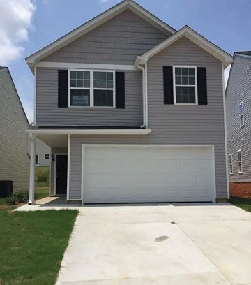 Covington house for rent - A grey house with a white garage door.