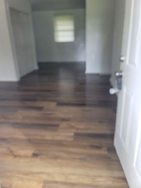 Atlanta house for rent - A hallway with a wooden floor and a white door.