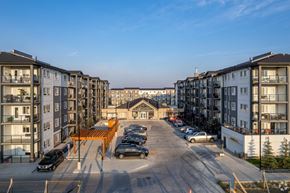 Calgary apartment for rent - A parking lot in front of apartment buildings.