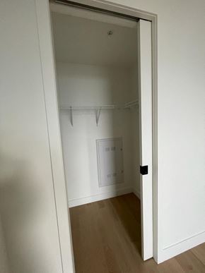Montréal apartment for rent - A white door is open to a room with a wooden floor.