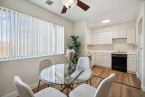 Altoona apartment for rent - A modern dining room with a glass table and white chairs.