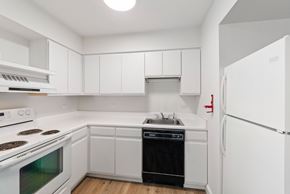 Altoona apartment for rent - A white kitchen with a stove, oven, dishwasher, and refrigerator.