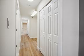 Altoona apartment for rent - A long hallway with white doors on the right side.