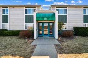 Altoona apartment for rent - The front of a building with a green awning and the number 300 on it.