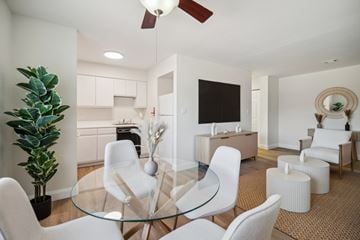 Altoona apartment for rent - A modern living room with a glass table and white chairs.