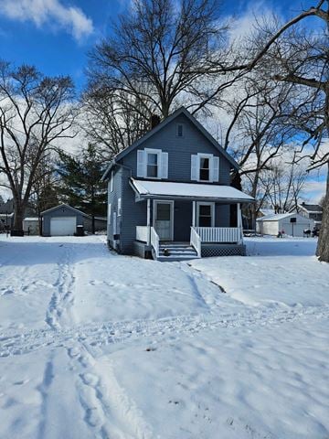 Warren house for rent - A house with a porch and a snow-covered ground.