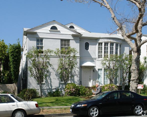 Beverly Hills apartment for rent - A large white house with a black car parked in front.