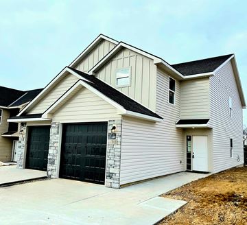 Warrensburg house for rent - A two-story house with a garage on the first floor.