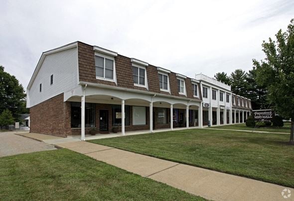 Pequannock apartment for rent - A long building with a white front and a brown roof.