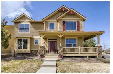 Parker house for rent - A two-story house with a red door and a balcony.
