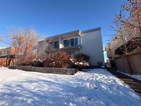 Calgary apartment for rent - A snow-covered ground with a building in the background.