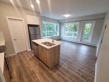 Calgary apartment for rent - A kitchen with a sink and a refrigerator.