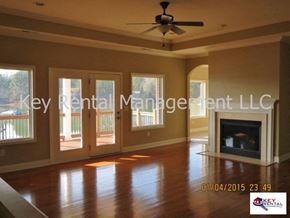 Loudon house for rent - A living room with a fireplace and a ceiling fan.