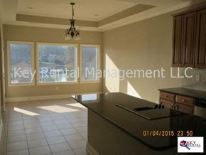 Loudon house for rent - A well-lit office space with a chandelier and a desk.