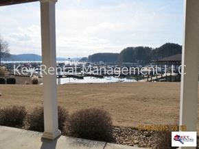 Loudon house for rent - A view from a porch looking out over a field with a body of water and trees in the distance.
