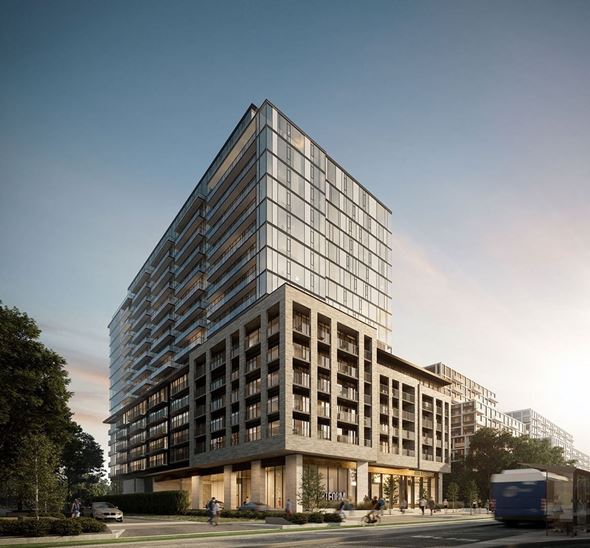 Toronto apartment for rent - A modern glass building with a street in front of it.