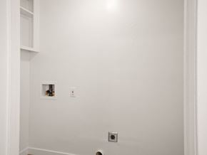 San Leandro apartment for rent - A white wall with a small picture and a light switch.