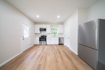 Phenix City house for rent - A kitchen with a refrigerator on the right side.